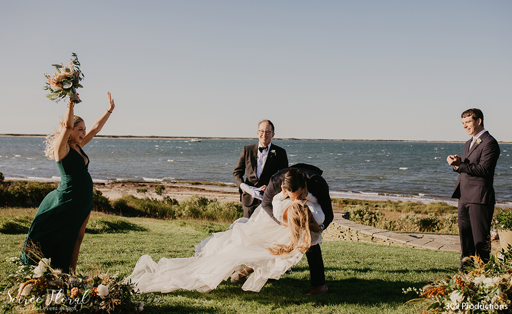 Boho Chic Micro Wedding Sweeping Bride and Groom Kiss. Bridesmaid cheering, Groomsman clapping. Photo by 309 Productions.