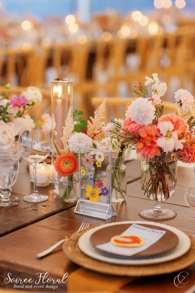 placesetting with orange, pink, and white flowers