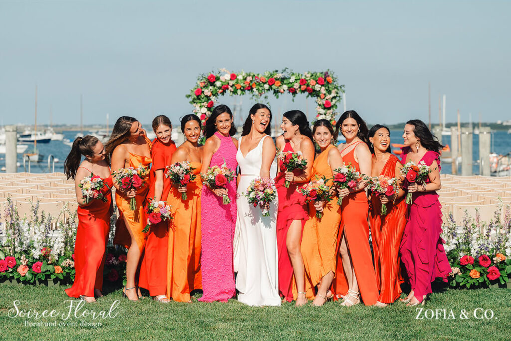 bride and bridesmaids in sunset colored dresses
