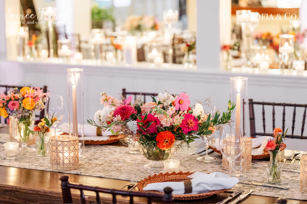wedding table with vibrant floral centerpiece and candles