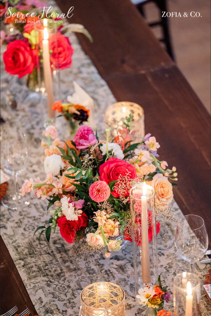 Vibrant wedding flowers with candles