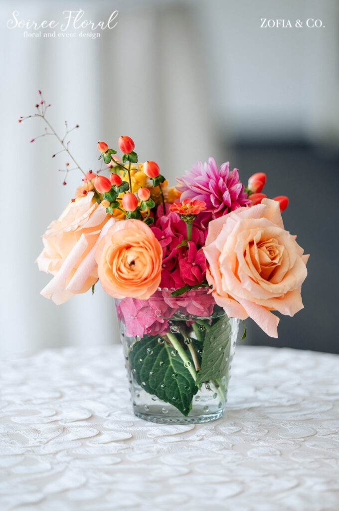 vibrant wedding flowers in glass vase